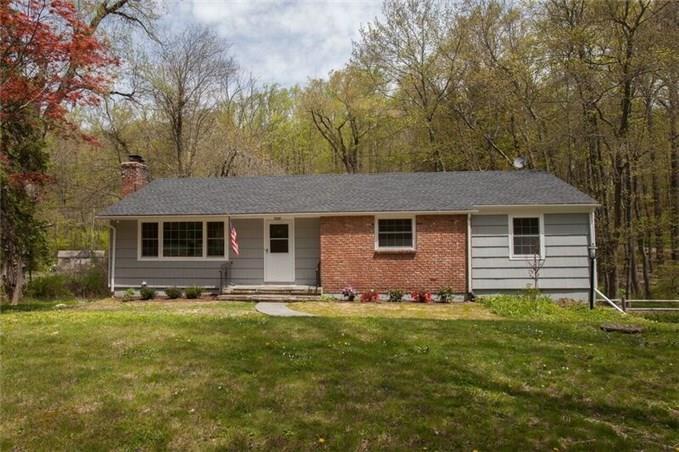 102 Barrack Hill Road Ridgefield, CT 06877 - Photo 1 of 1 a front view of house with yard and trees in the background