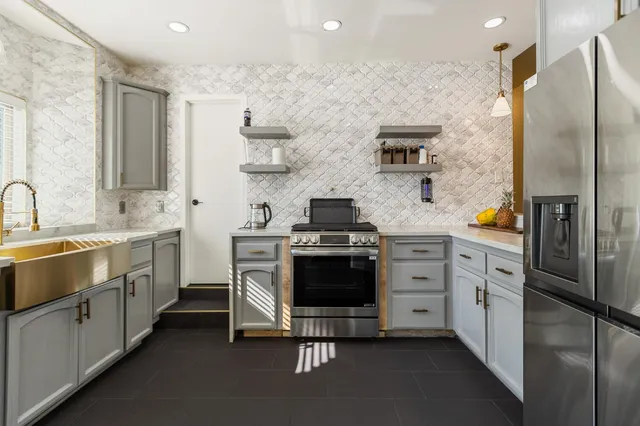 a view of a porch with chairs and potted plants