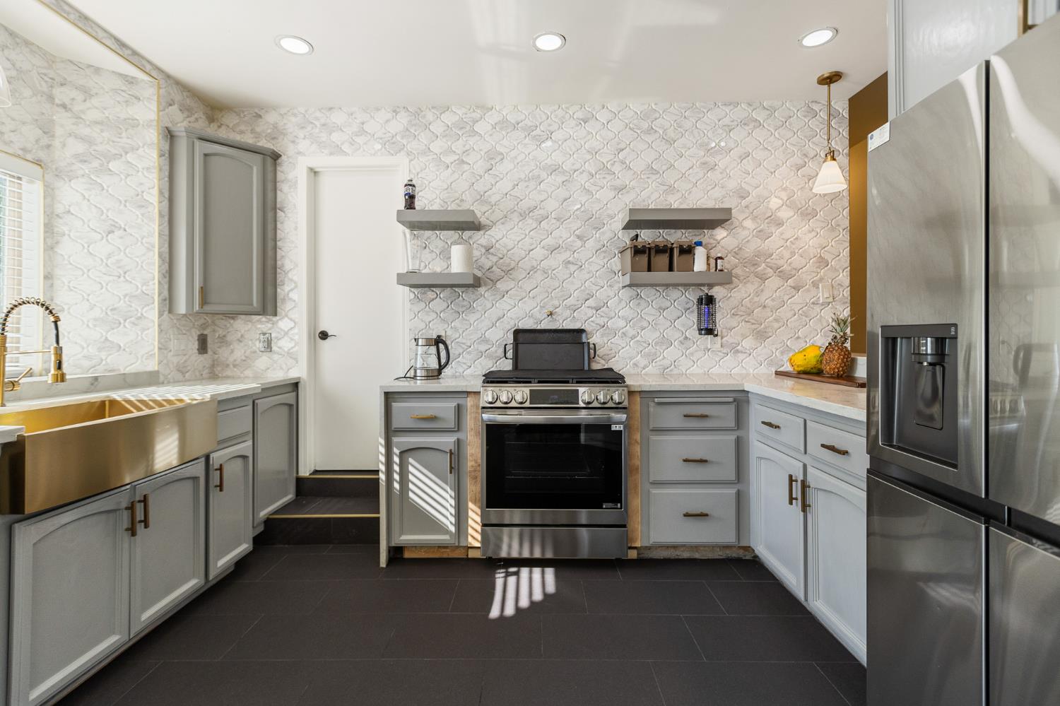 915 South Strathmore Avenue, Unit I Lindsay, CA 93247 - Photo 14 of 51 a kitchen with stainless steel appliances a stove a sink and a refrigerator