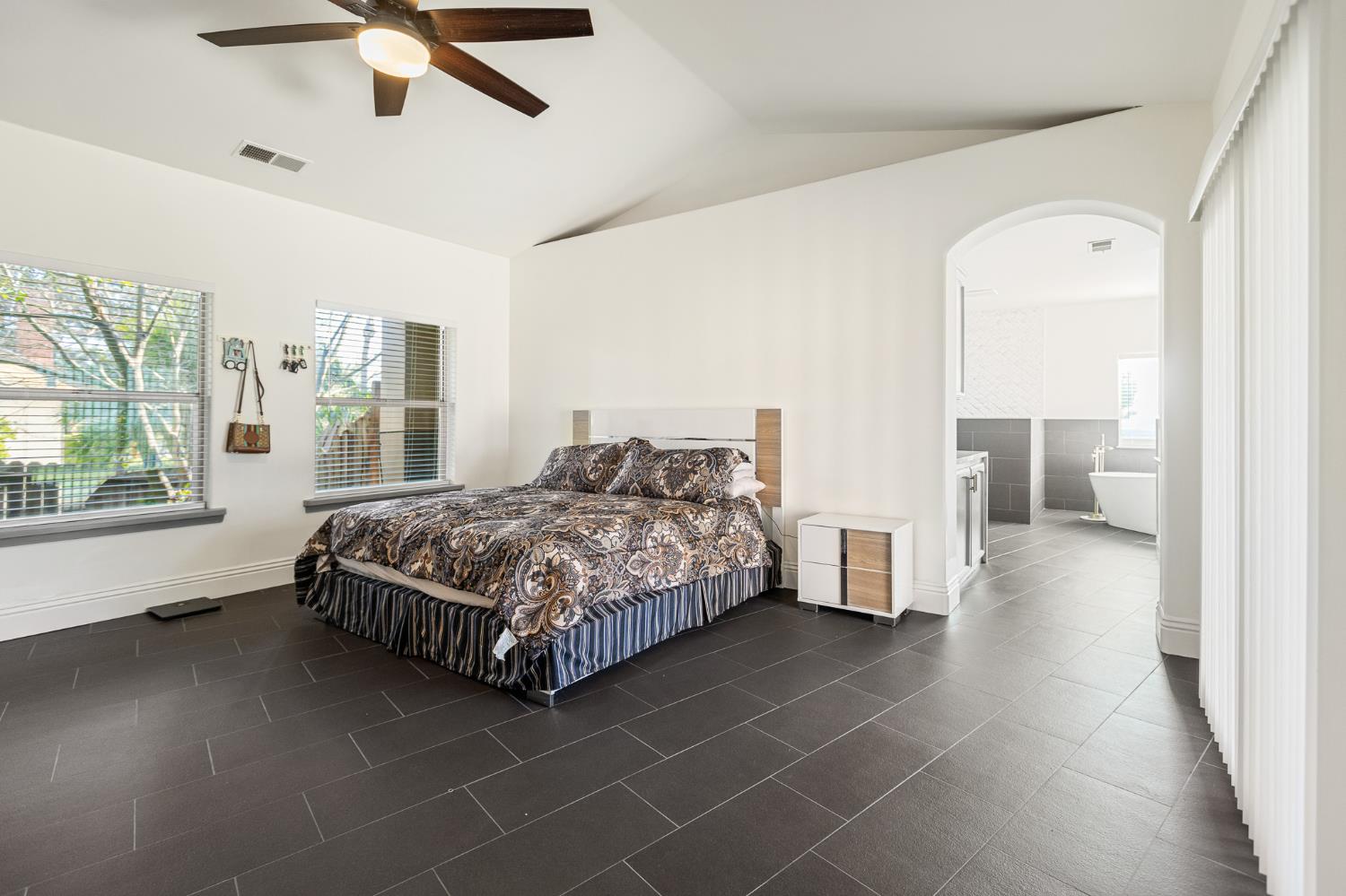 915 South Strathmore Avenue, Unit I Lindsay, CA 93247 - Photo 15 of 51 a bedroom with a bed and a large window