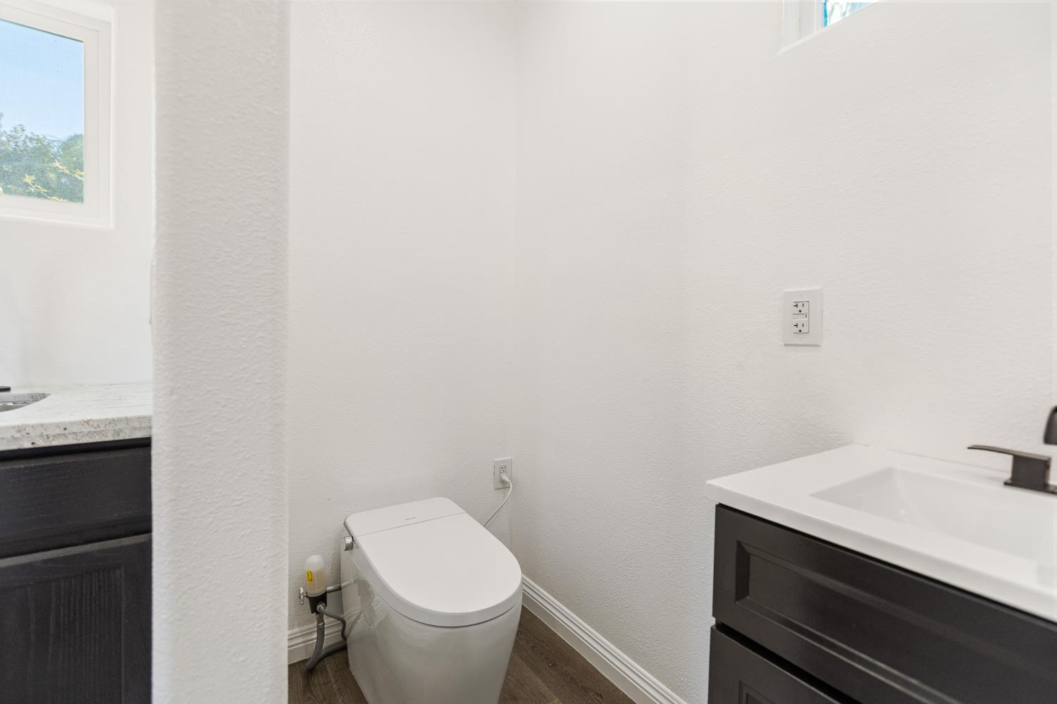 915 South Strathmore Avenue, Unit I Lindsay, CA 93247 - Photo 36 of 51 a bathroom with a sink a toilet and a window