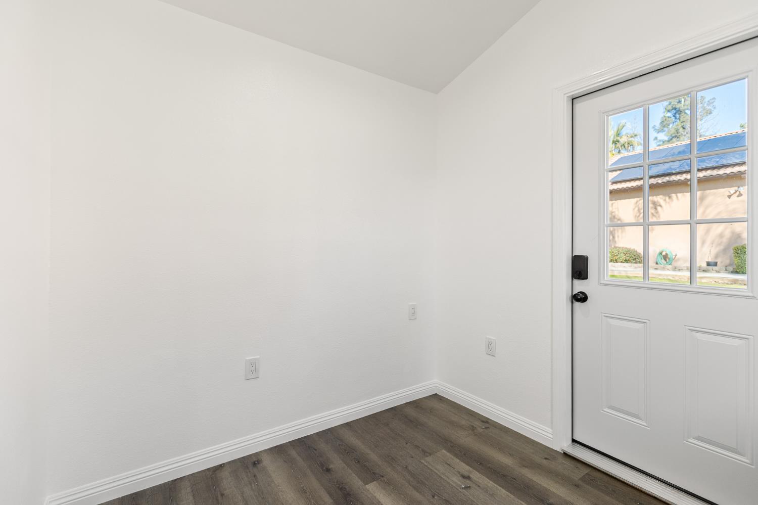 915 South Strathmore Avenue, Unit I Lindsay, CA 93247 - Photo 37 of 51 a view of an empty room with wooden floor and windows