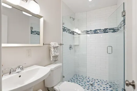 a bathroom with a sink toilet and shower