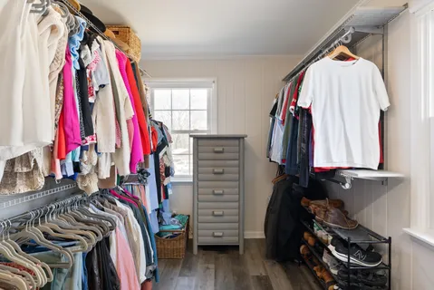 a view of walk in closet with clothes