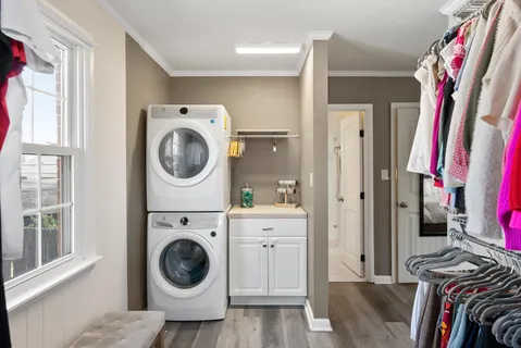 a view of a bedroom with washer and dryer