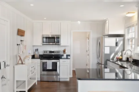 a kitchen with stainless steel appliances granite countertop a stove and a sink