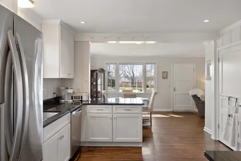 a kitchen with a sink stainless steel appliances and cabinets