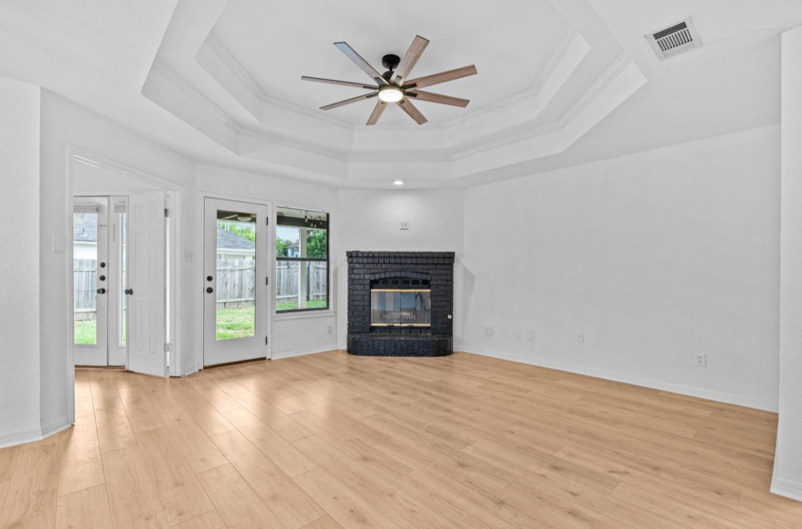 2101 Boxwood Path Round Rock, TX 78664 - Photo 14 of 22 a view of an empty room with wooden floor and a fireplace