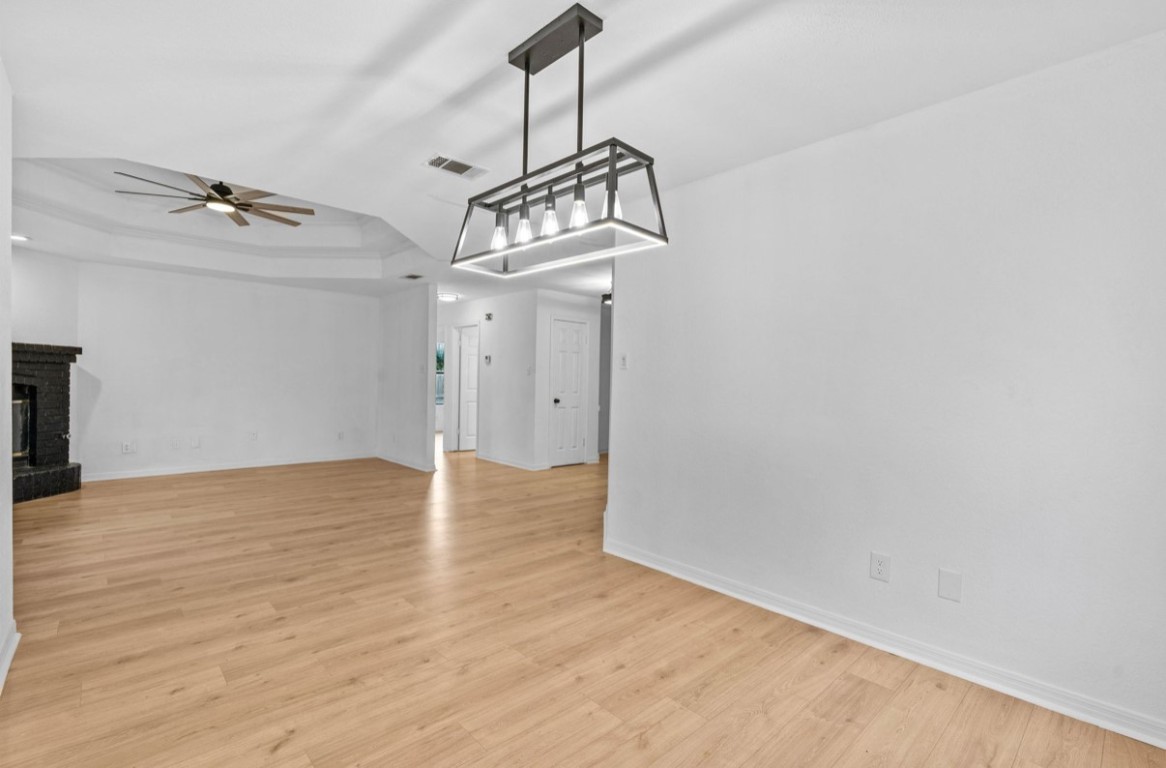 2101 Boxwood Path Round Rock, TX 78664 - Photo 17 of 22 a view of a chandelier fan and wooden floor