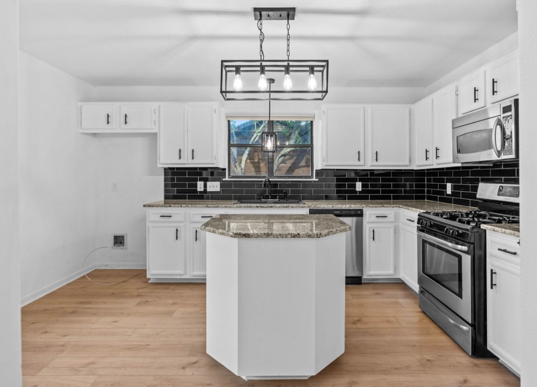 2101 Boxwood Path Round Rock, TX 78664 - Photo 3 of 22 a kitchen with stainless steel appliances granite countertop a stove a sink and white cabinets