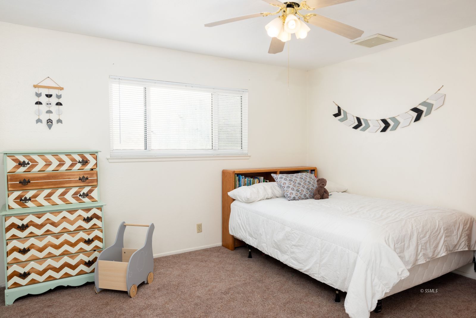 530 South Warner Street Ridgecrest, CA 93555 - Photo 27 of 32 a bedroom with a bed and a chandelier