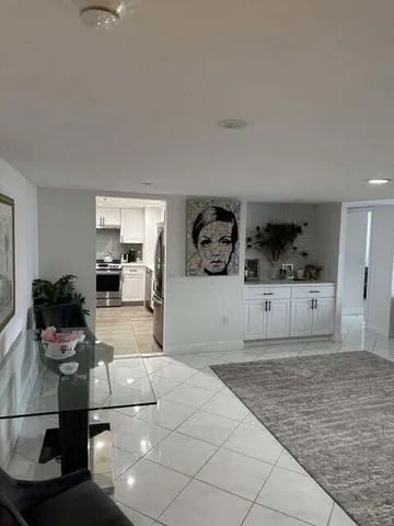 a living room with furniture and kitchen view