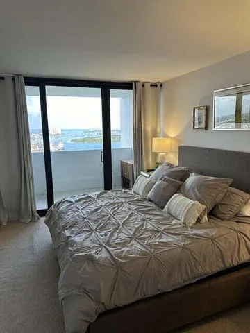 a bedroom with a large bed and a large window