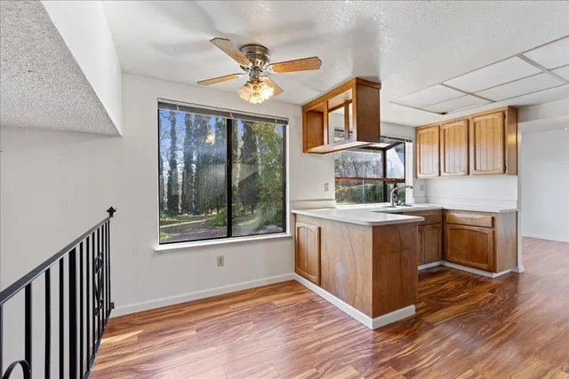a kitchen with stainless steel appliances granite countertop a stove a sink and a refrigerator