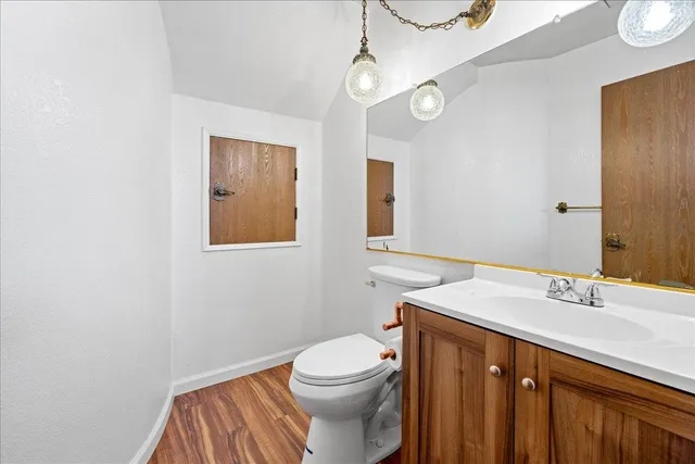 a bathroom with a sink a toilet and mirror