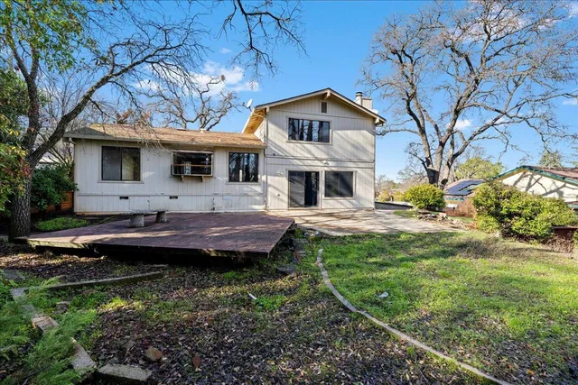 a front view of a house with a yard table and chairs