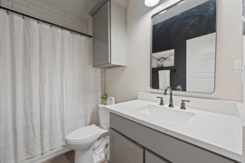 1031 Augustus Court Rio Vista, TX 76093 - Photo 14 of 30 Bathroom featuring a white integrated sink, light-toned countertop, and gray vanity cabinetry