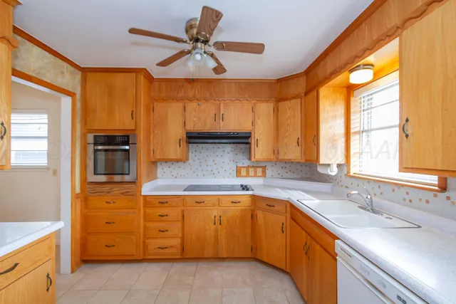 a kitchen with appliances cabinets and a sink