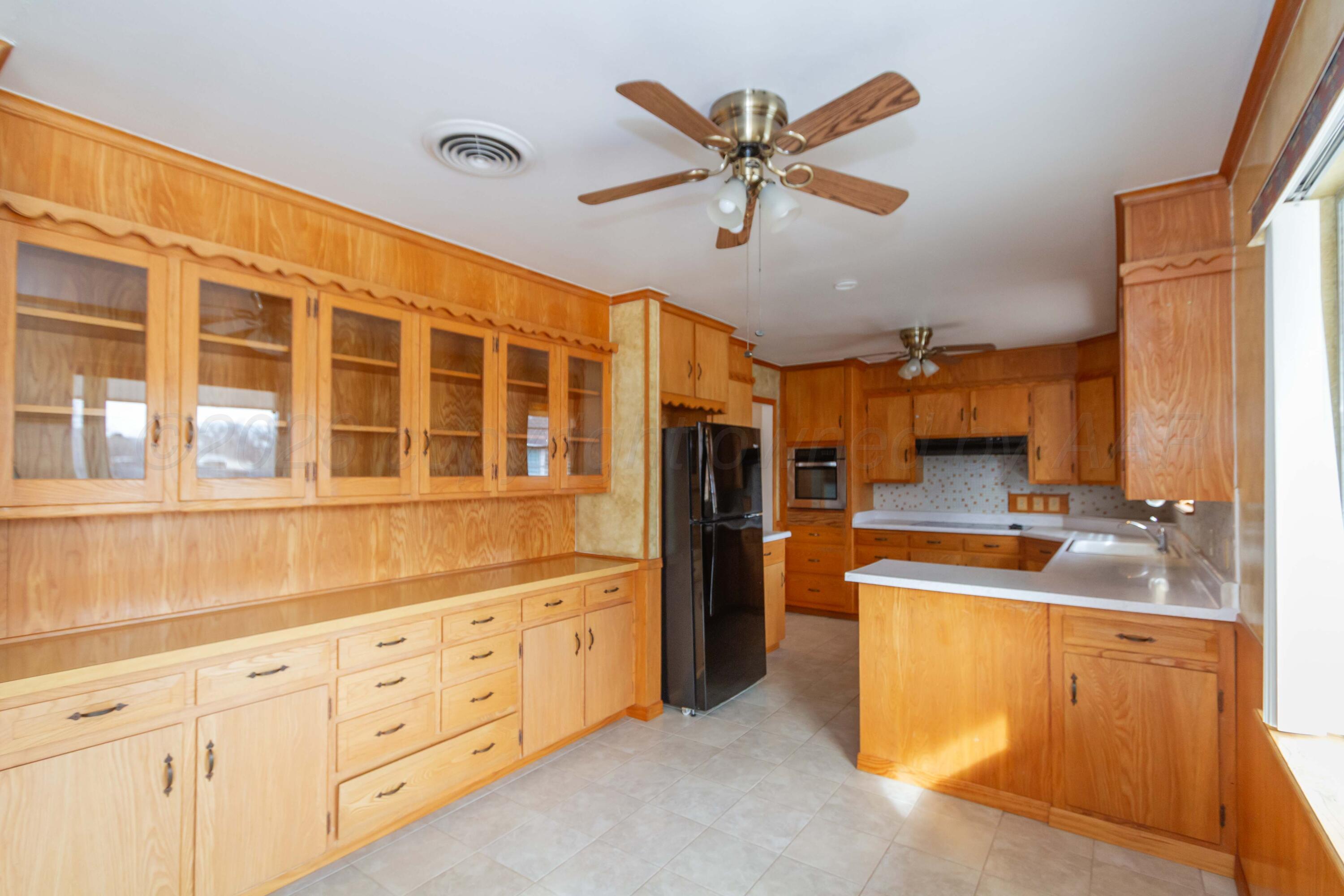 105 Wilson Street Claude, TX 79019 - Photo 13 of 31 a kitchen with cabinets appliances and a window