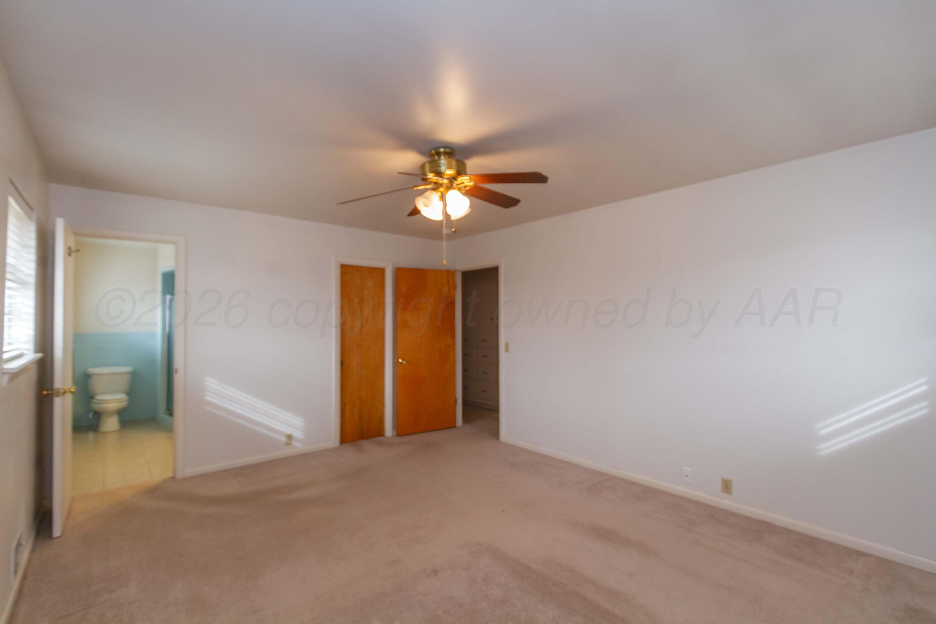 105 Wilson Street Claude, TX 79019 - Photo 16 of 31 an empty room with closet and a chandelier fan
