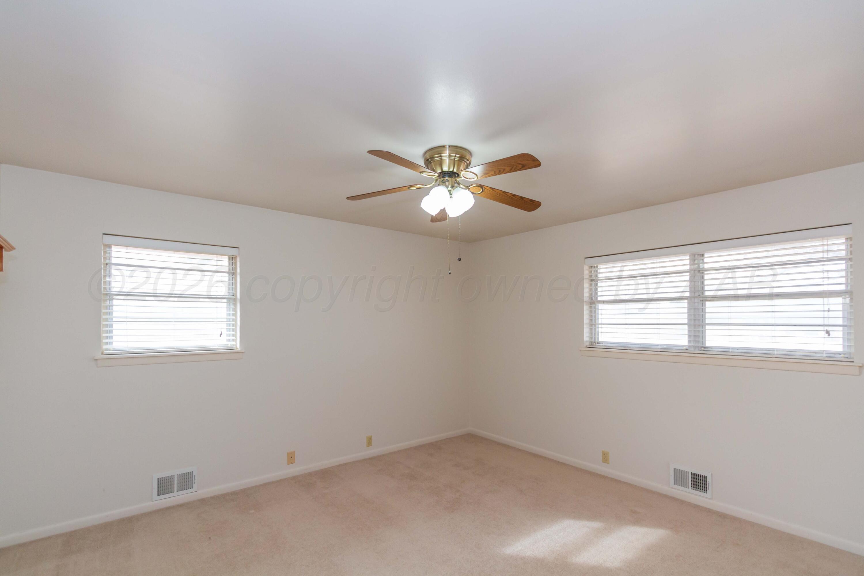 105 Wilson Street Claude, TX 79019 - Photo 19 of 31 an empty room with a window and a fan