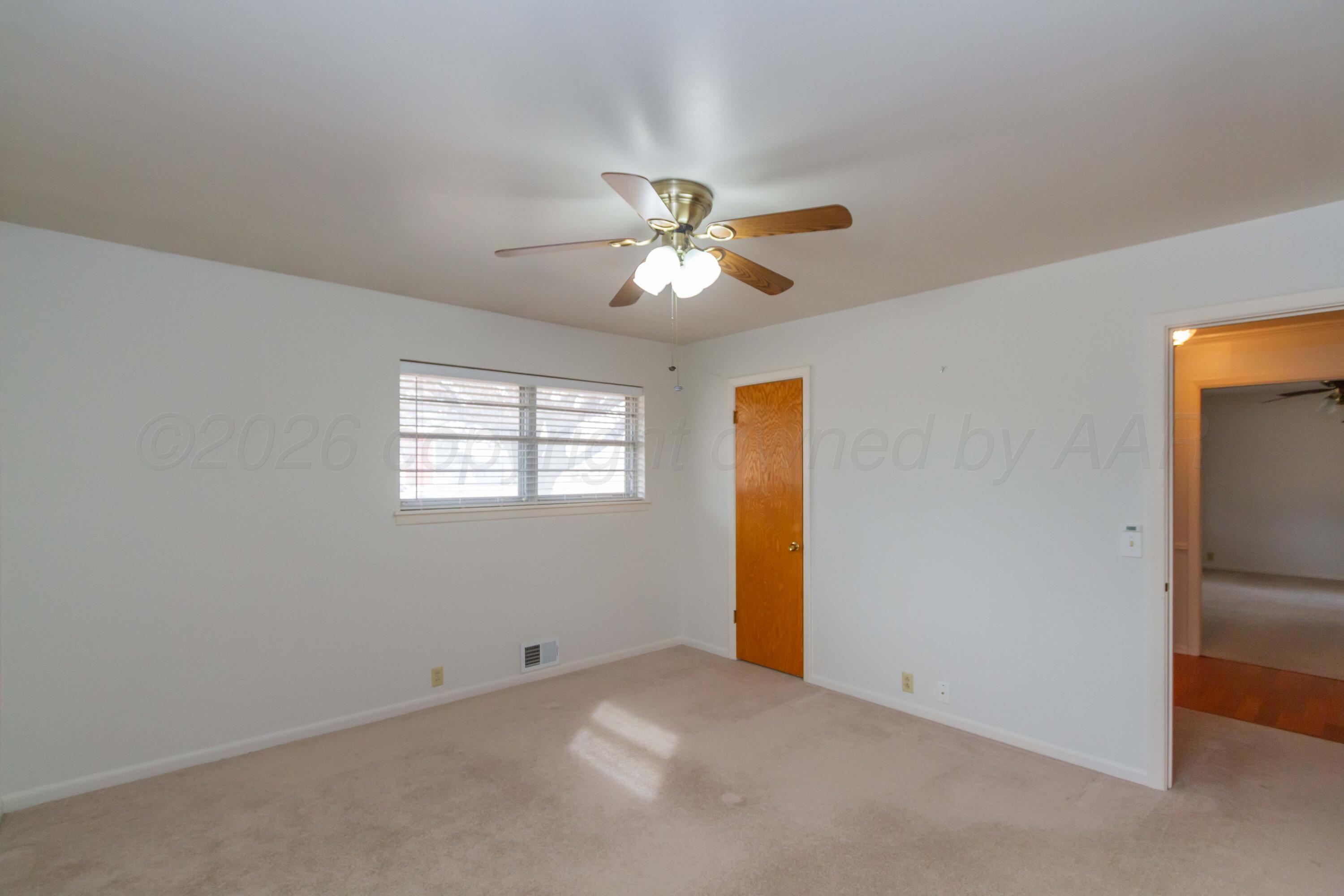 105 Wilson Street Claude, TX 79019 - Photo 20 of 31 an empty room with closet and a ceiling fan