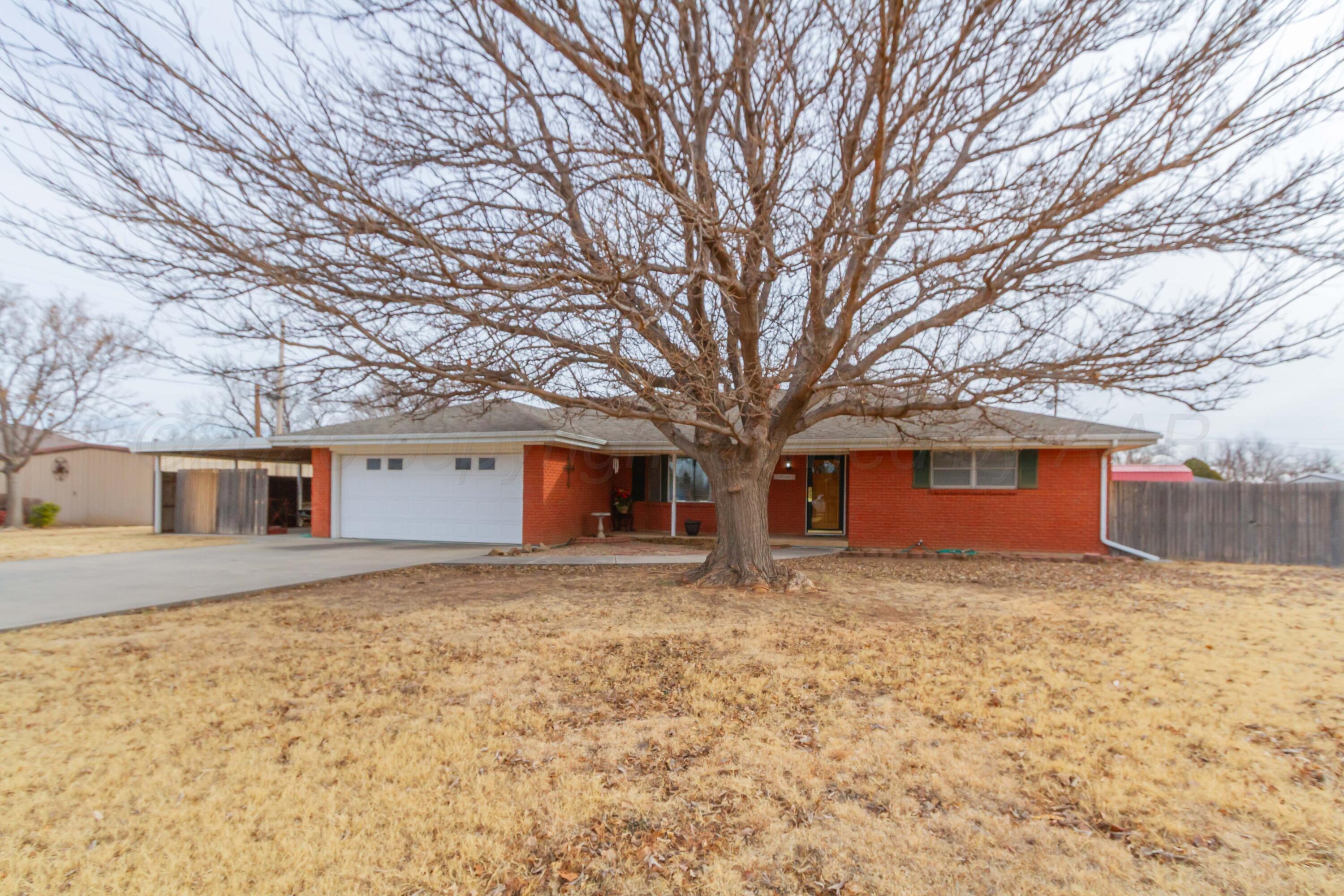105 Wilson Street Claude, TX 79019 - Photo 2 of 31 a house with trees in front of it