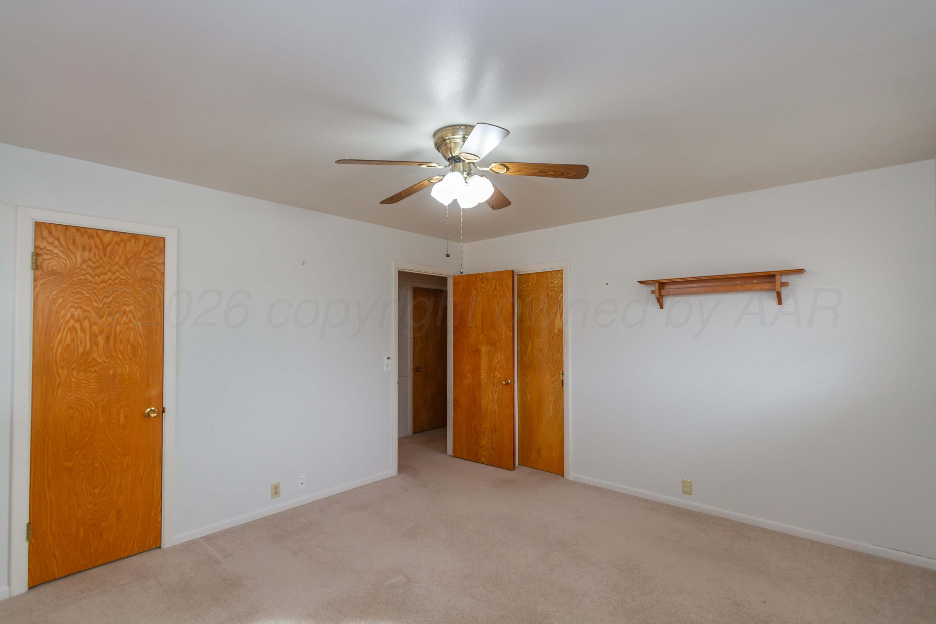 105 Wilson Street Claude, TX 79019 - Photo 21 of 31 a view of a room with a ceiling fan and a window