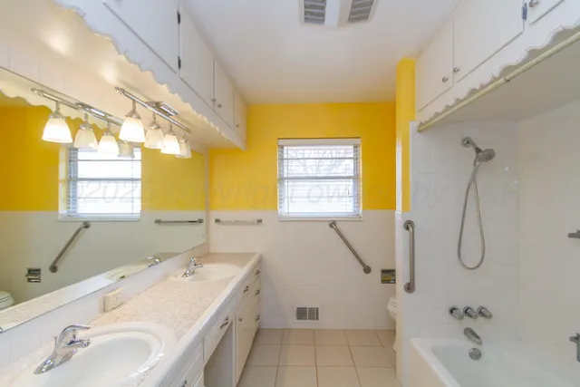 a bathroom with a tub sink and window