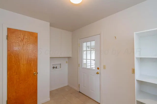 a view of a livingroom with wooden floor and windows