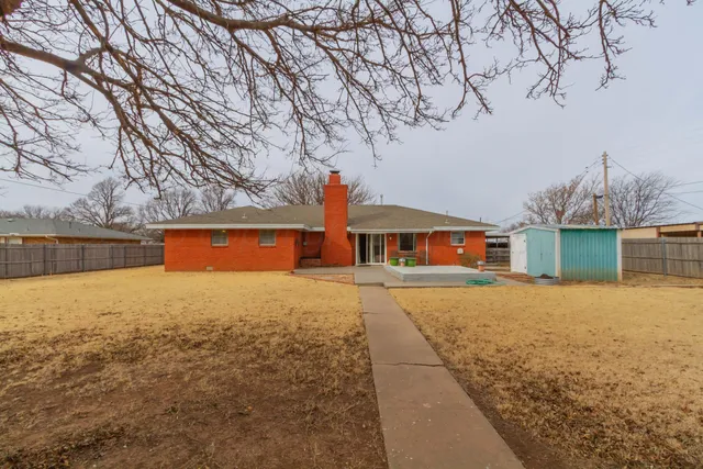 a front view of house with yard and trees