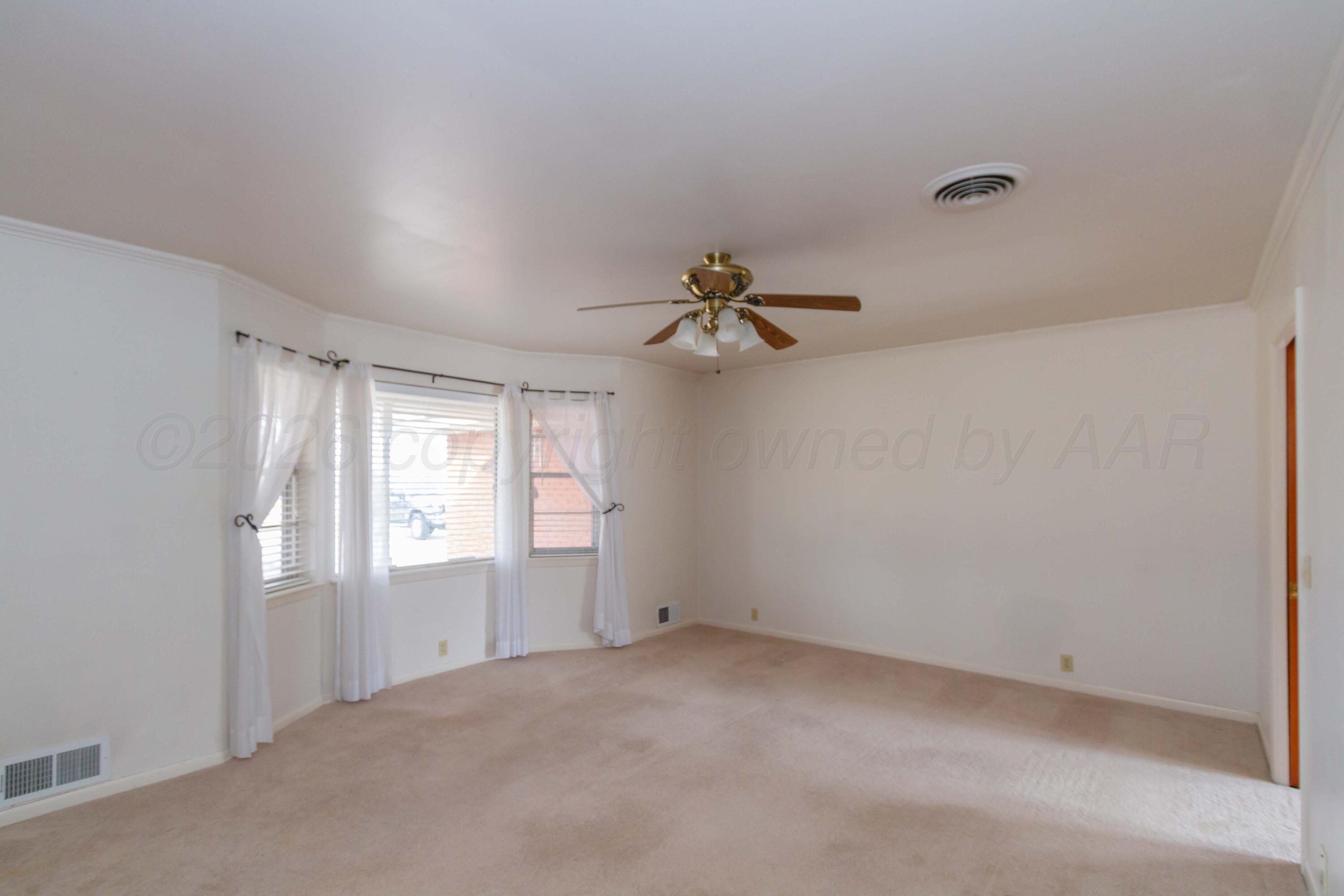 105 Wilson Street Claude, TX 79019 - Photo 5 of 31 a view of empty room with windows