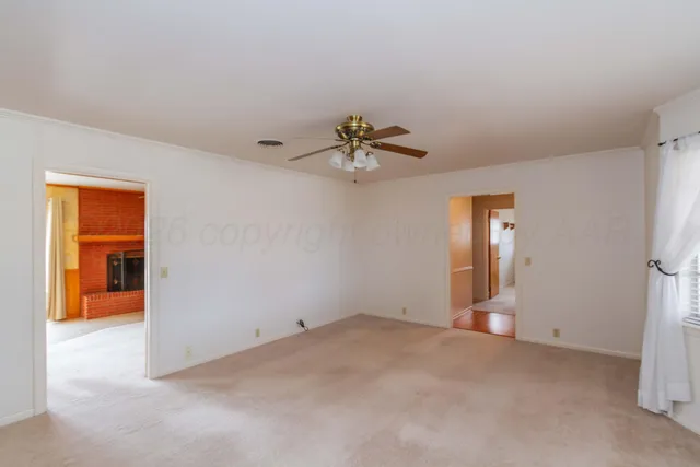 a view of a livingroom with a ceiling fan and window
