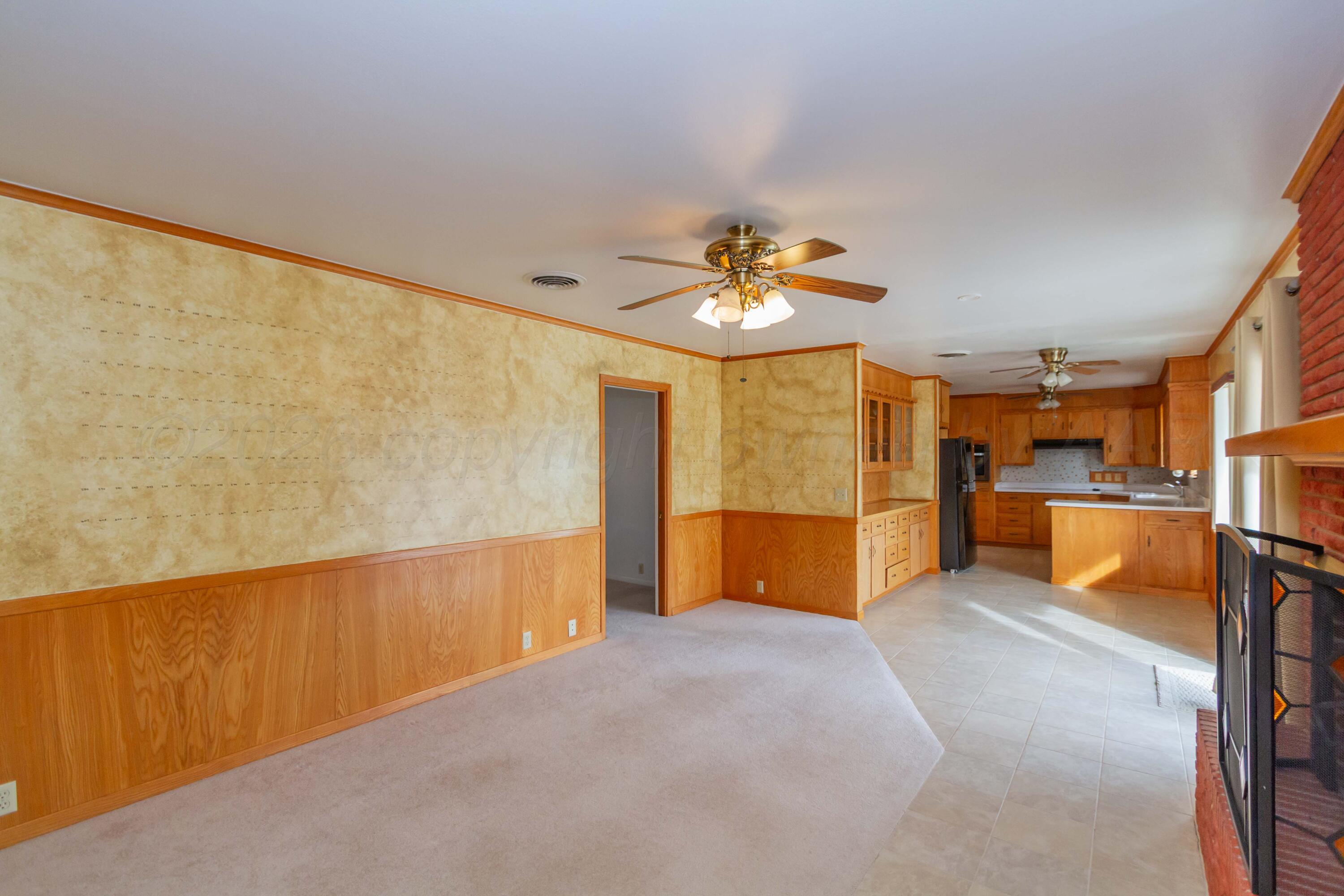 105 Wilson Street Claude, TX 79019 - Photo 8 of 31 a view of an empty room with a chandelier