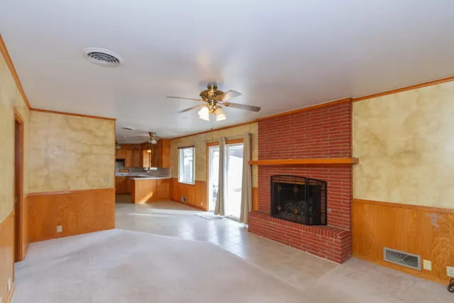 a view of a livingroom with an empty space and a fireplace