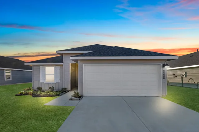 a front view of house with yard and garage