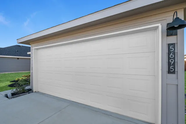 a front view of a house with a garden and yard