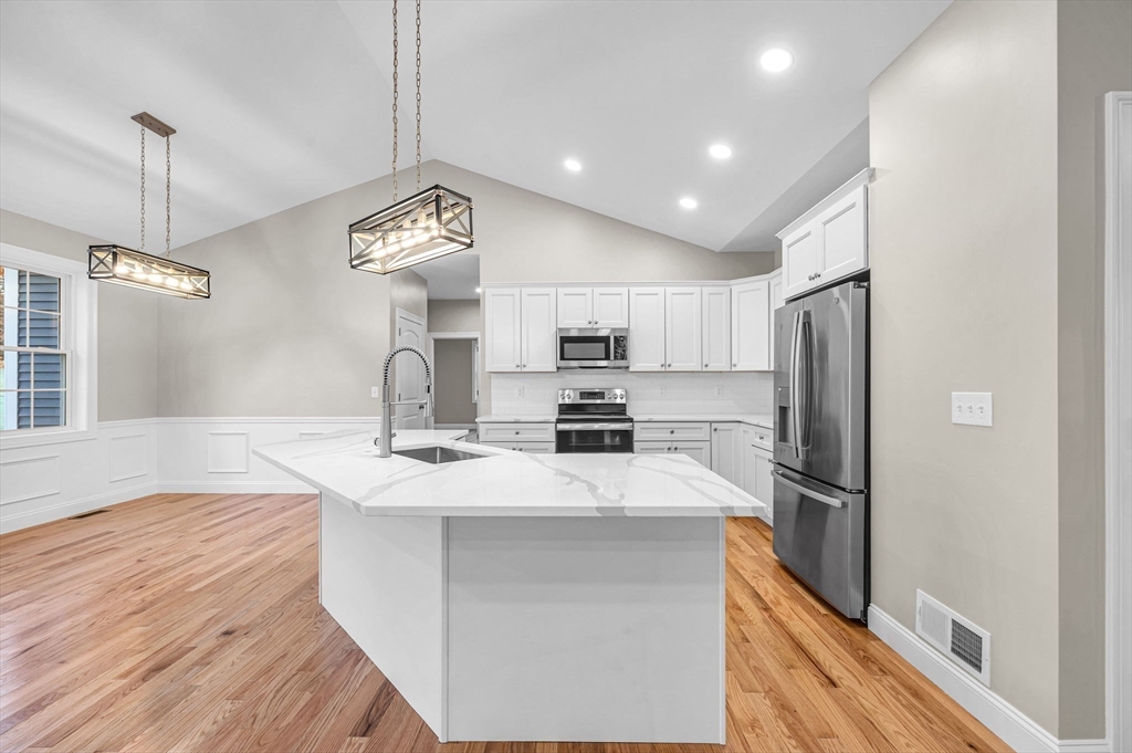 15 High Blf Road Belchertown, MA 01007 - Photo 14 of 41 a kitchen with refrigerator cabinets and wooden floor