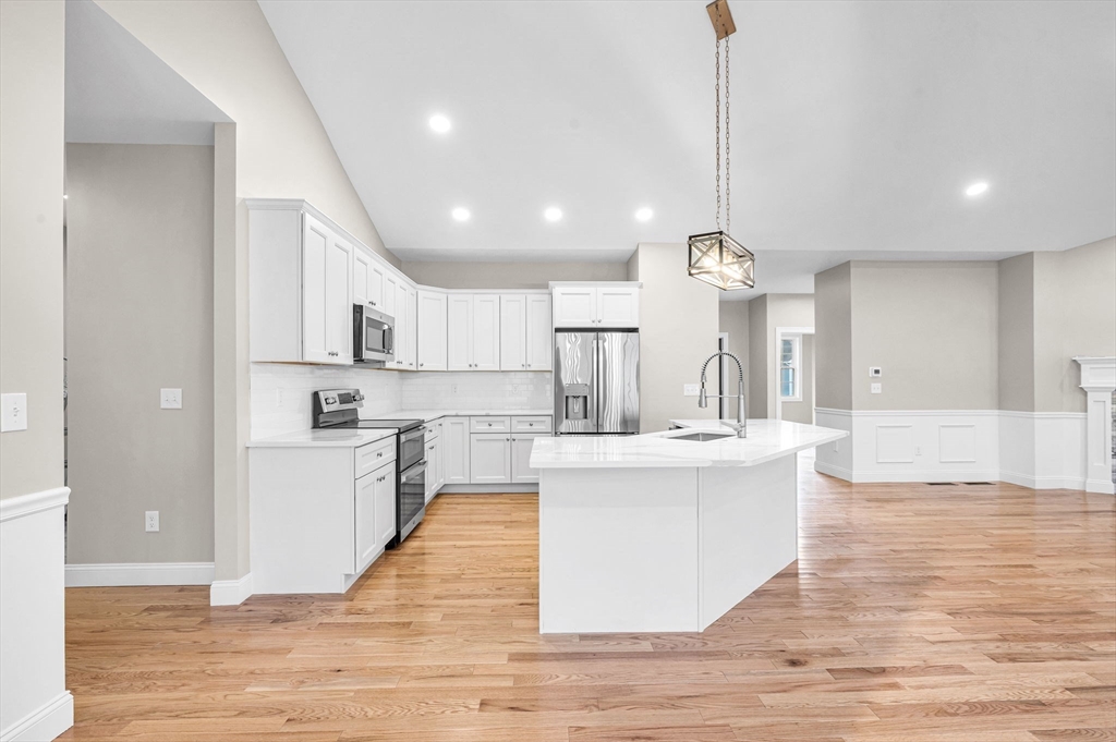 15 High Blf Road Belchertown, MA 01007 - Photo 16 of 41 a large kitchen with kitchen island a stove a sink a center island and wooden floor