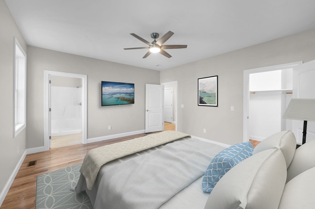 15 High Blf Road Belchertown, MA 01007 - Photo 22 of 41 a bedroom with a large bed and a chandelier