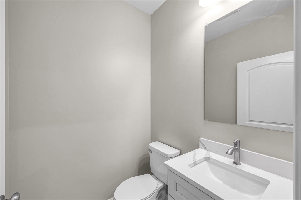 15 High Blf Road Belchertown, MA 01007 - Photo 34 of 41 a white toilet sitting next to a bathroom sink