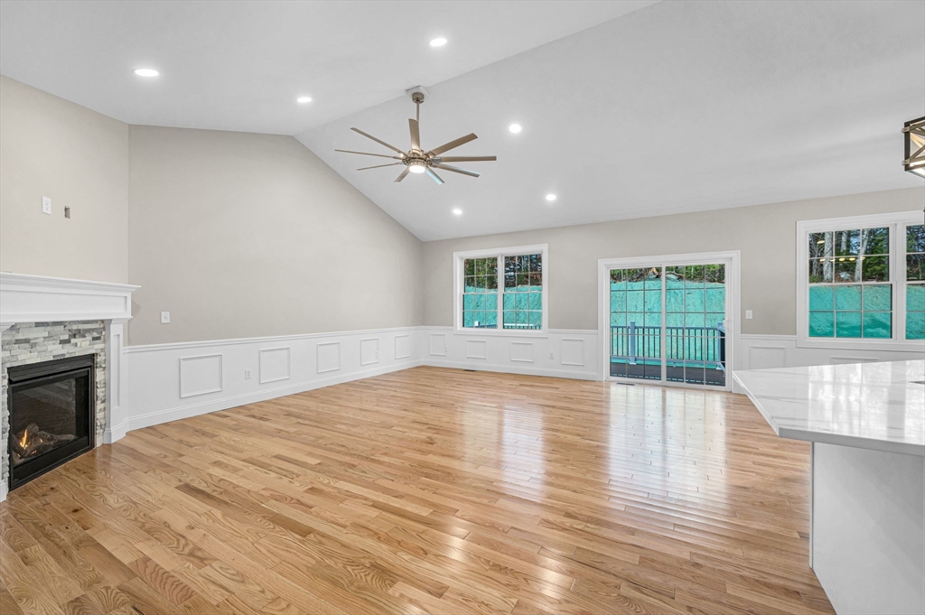15 High Blf Road Belchertown, MA 01007 - Photo 6 of 41 an empty room with wooden floor and fireplace