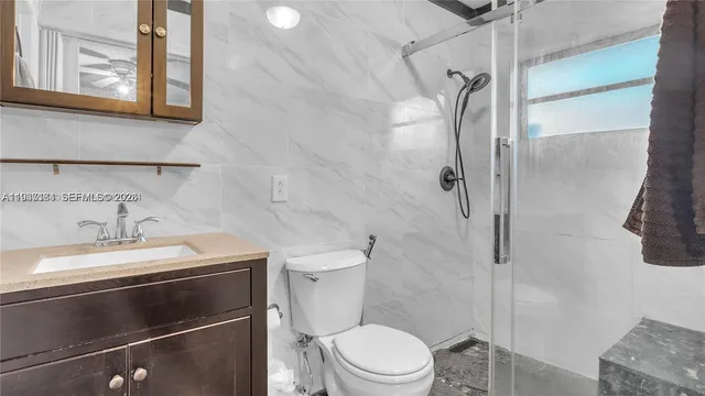 a bathroom with a sink toilet and shower