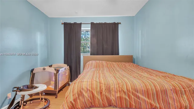 a bedroom with bed and chair