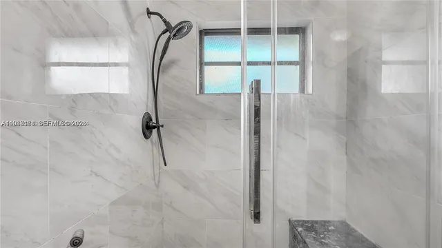 a bathroom with a glass shower door