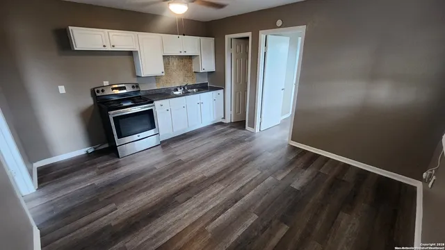 a kitchen with granite countertop a stove and a refrigerator