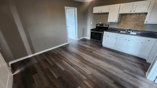 a kitchen with a sink and cabinets