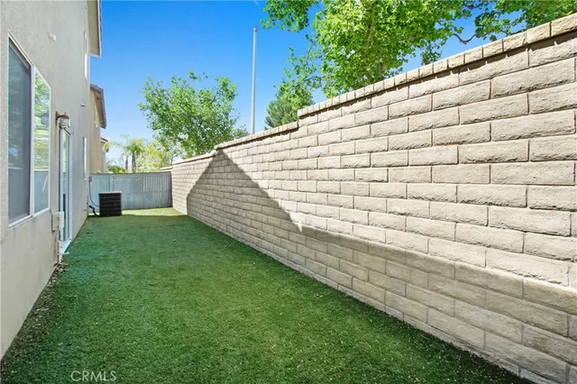 a view of house with backyard