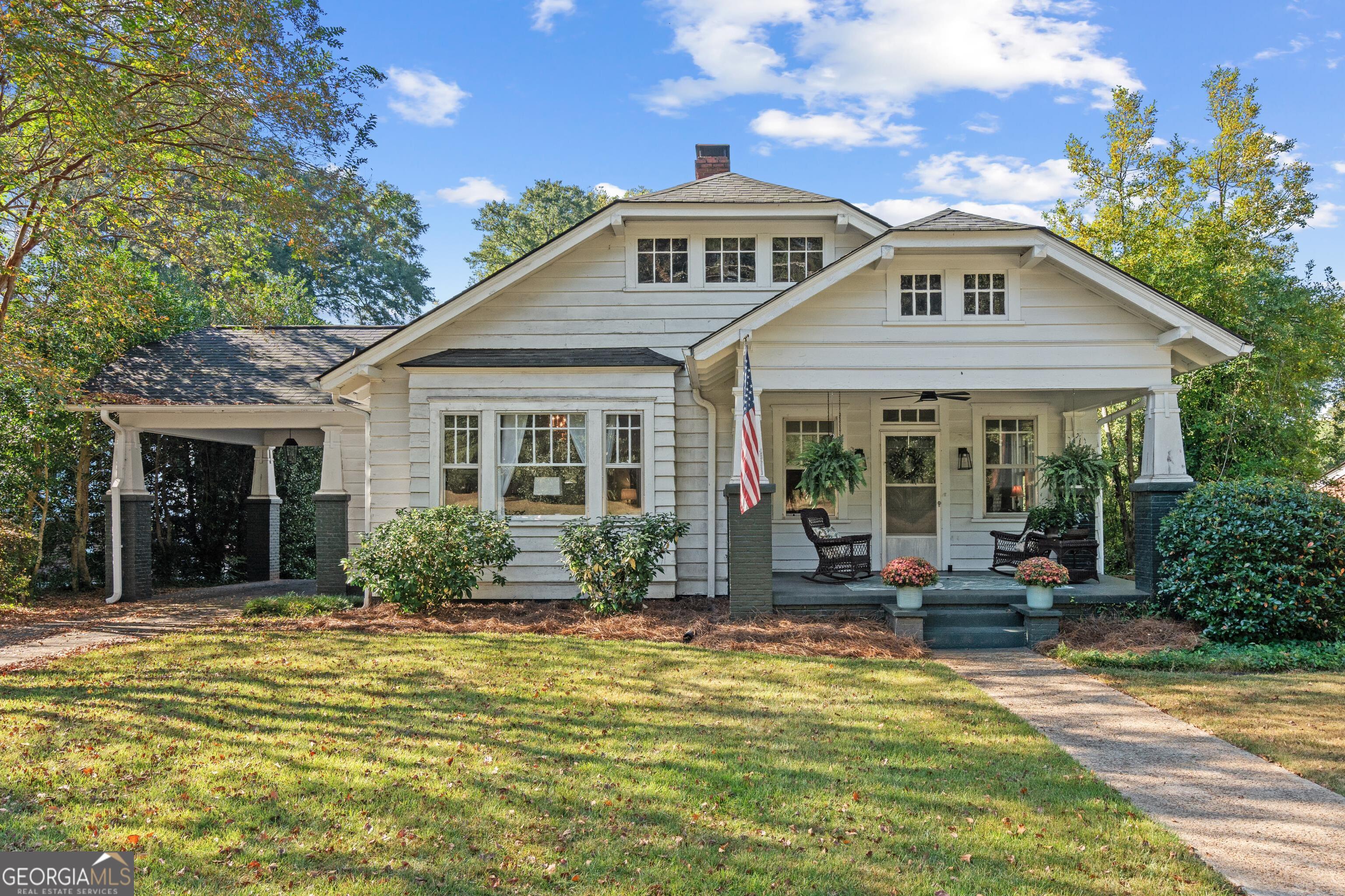 a front view of a house with swimming pool and glass windows