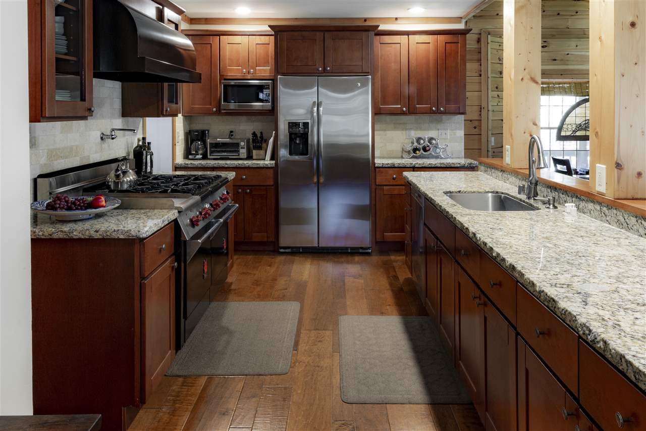 12051 Oslo Drive Truckee, CA 96161 - Photo 11 of 21 a kitchen with stainless steel appliances granite countertop a stove a sink and a refrigerator